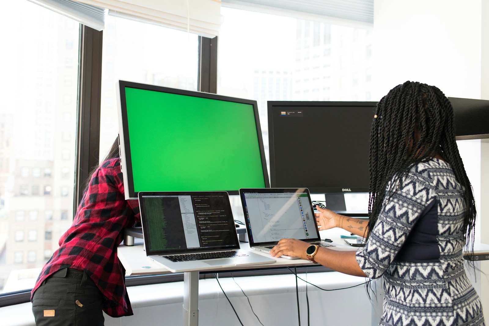 shallow focus photo of woman using laptop computer