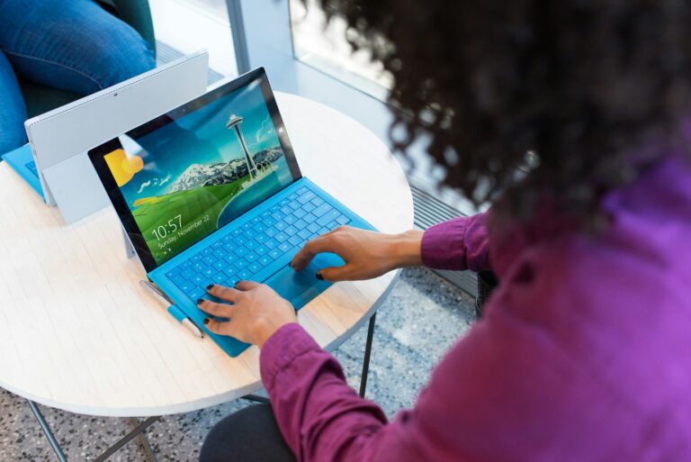 woman in purple sweater using laptop